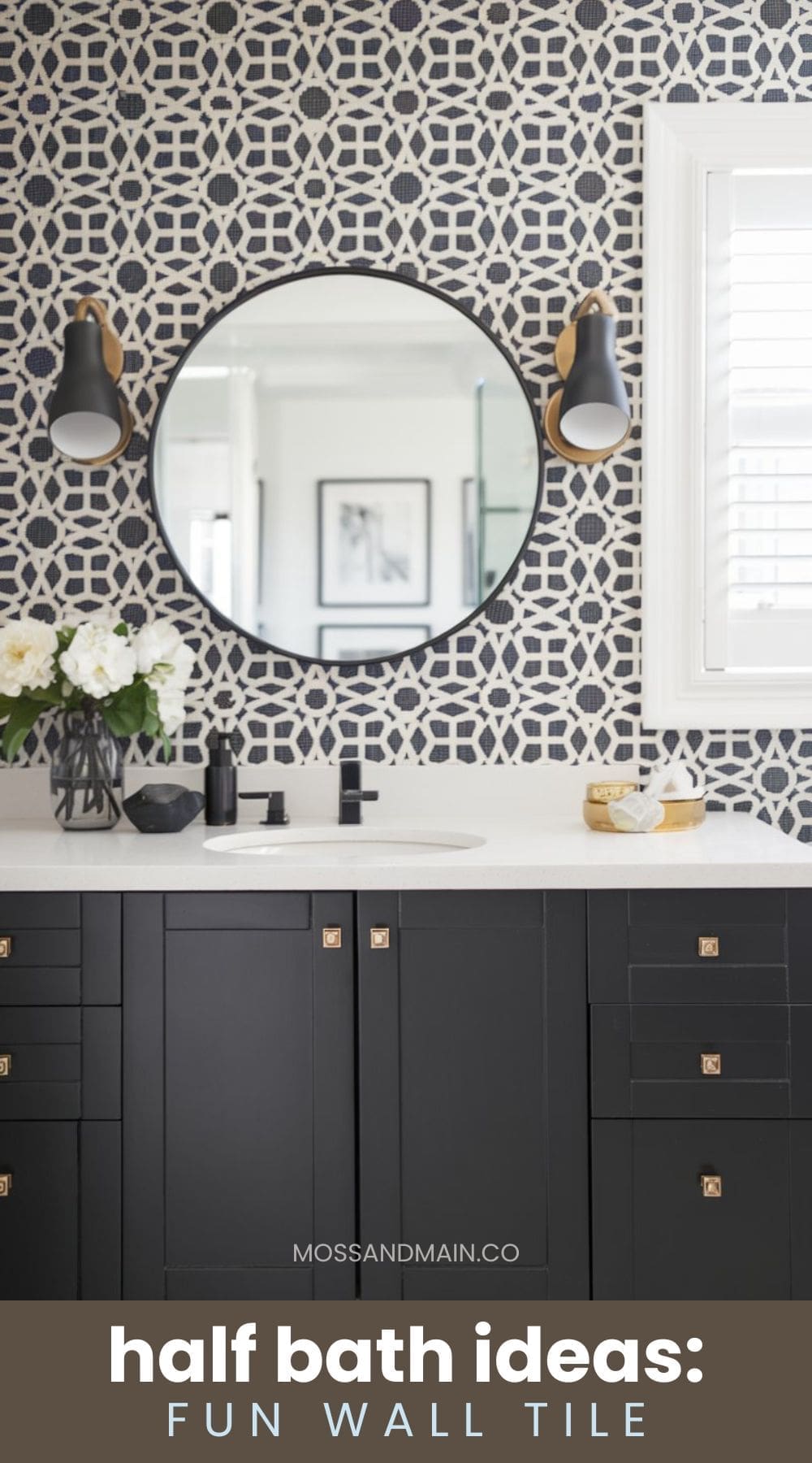 Modern half bath with a geometric black-and-white tiled wall, round mirror, and black cabinetry. Two wall sconces flank the mirror, and a white countertop features a small plant and accessories. Text reads half bath ideas: fun wall tile.