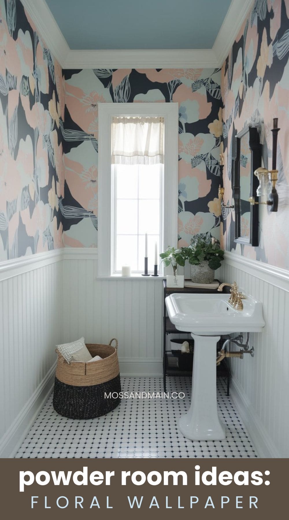 A small, elegant powder room with floral wallpaper, a white pedestal sink, and a window with sheer curtains. The lower walls are wainscoted. A woven basket and candles are on the floor. Text overlay reads, powder room ideas: floral wallpaper.
