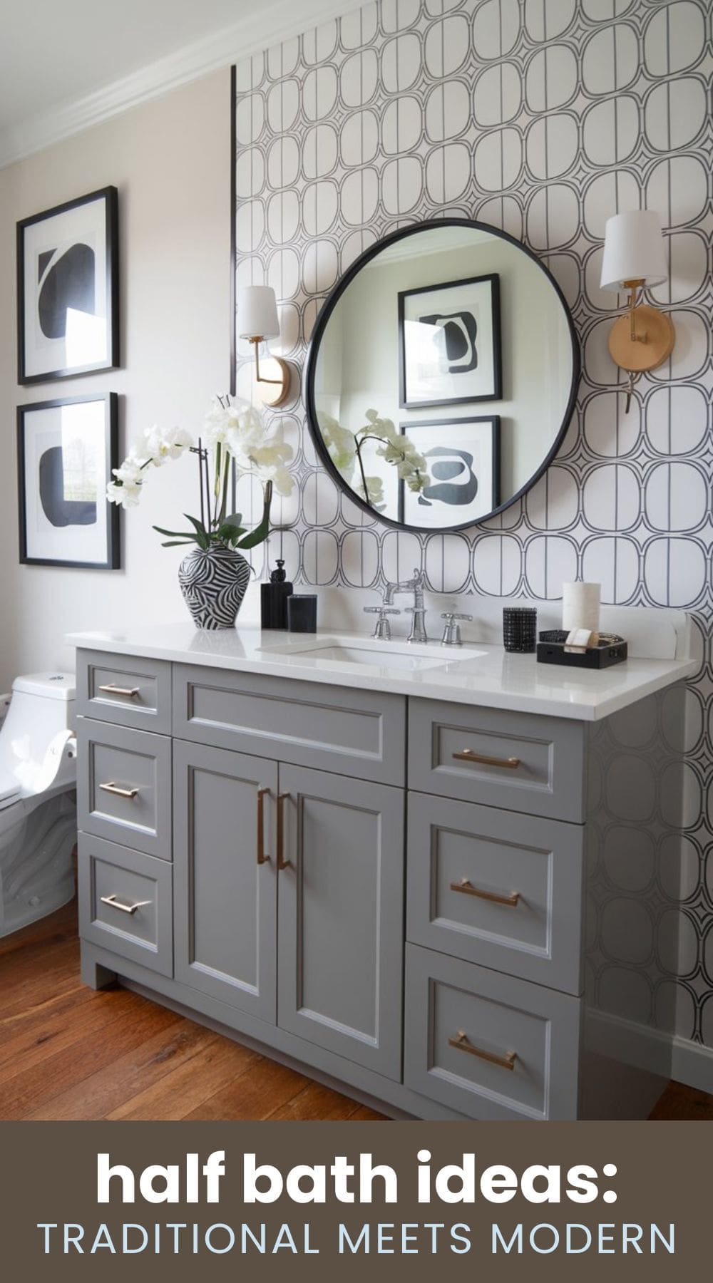 Gray bathroom with modern and traditional elements. Features a round mirror, patterned wallpaper, gray vanity with brass handles, white countertop, sink, and wall-mounted lights. Decor includes a vase with white orchids and black-and-white art. Text reads half bath ideas: TRADITIONAL MEETS MODERN.